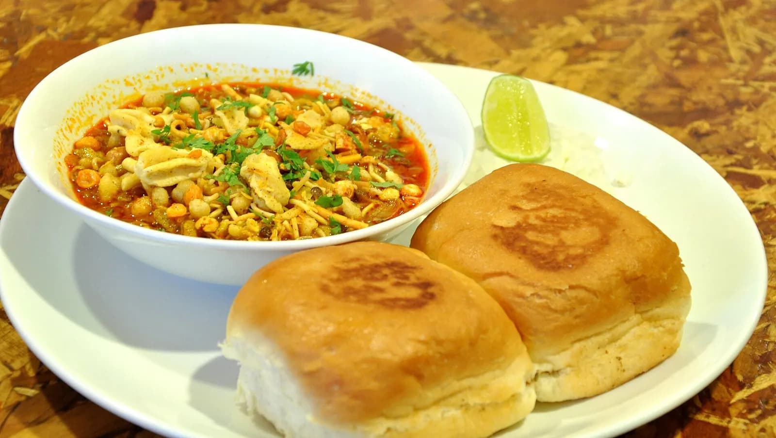 Misal pav: spicy sprout curry topped with farsan, served with pav